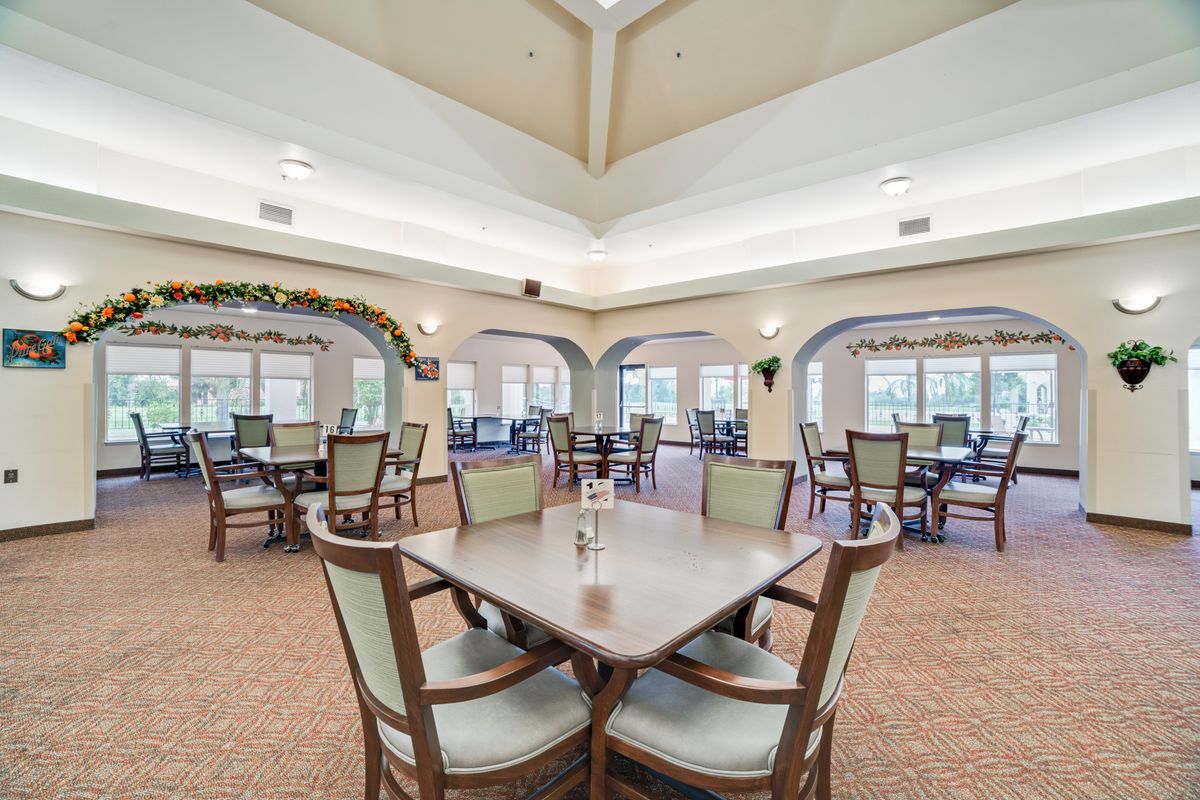 Interior view of Mission Commons senior living community featuring dining area, reception room, and art.