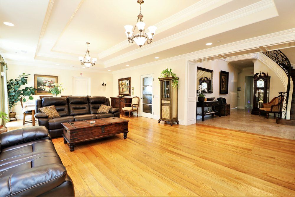 Wooden floored living room in Astoria Retirement Residences with elegant furniture and decor.