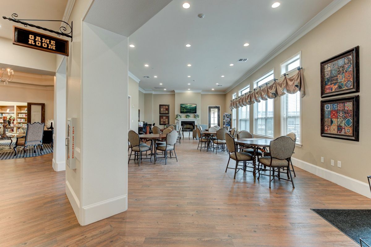 Interior view of Arabella of Athens senior living community featuring dining room and art decor.