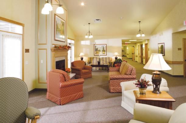 Senior living community room at The Courtyard at McHenry with cozy furniture and home decor.
