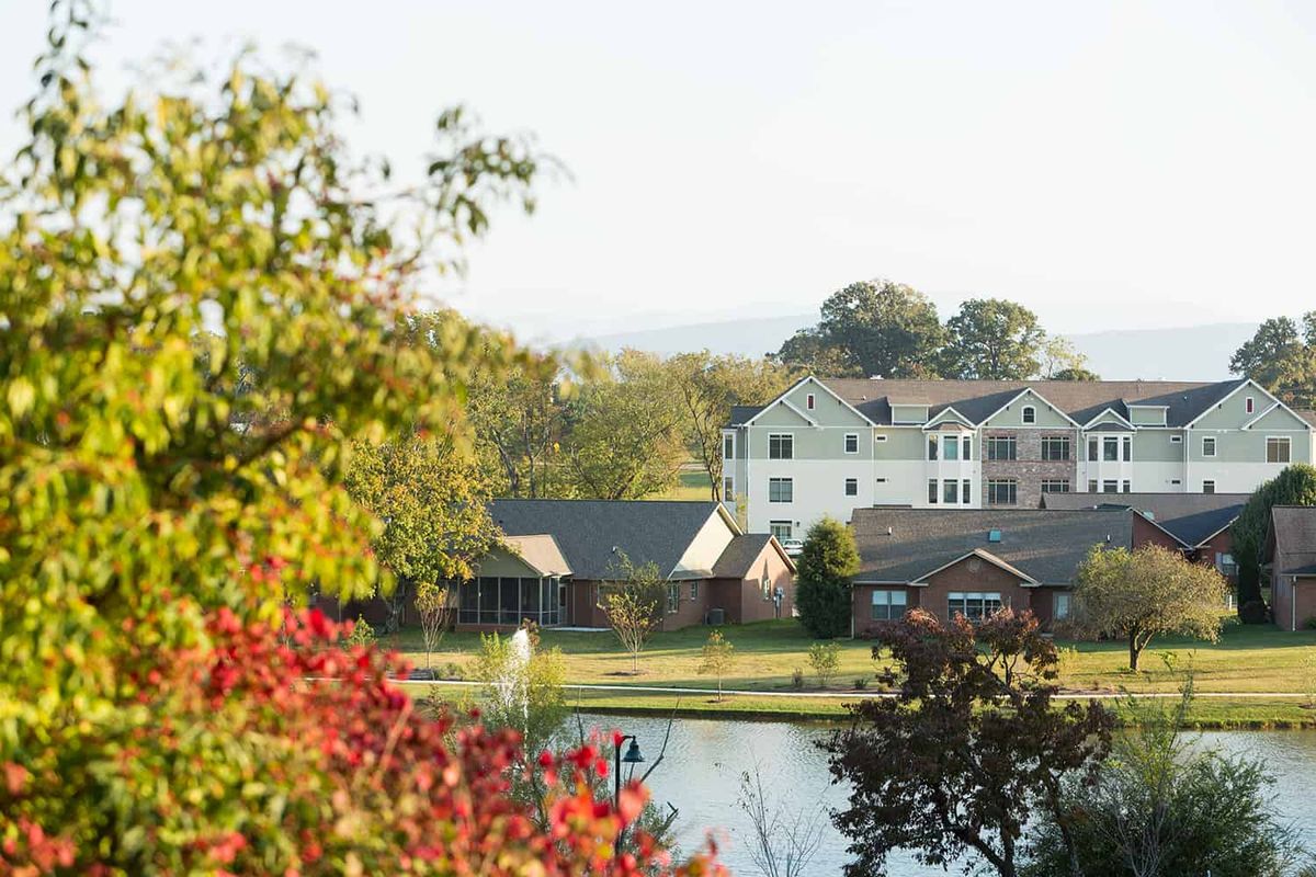 Scenic view of Asbury Place Maryville senior living community with lakefront and nature outdoors.