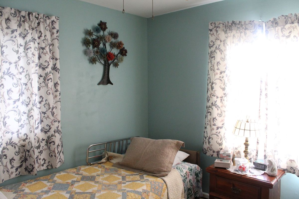 Home Decor and furniture in a comfortable bedroom at Anestis Senior Care community.