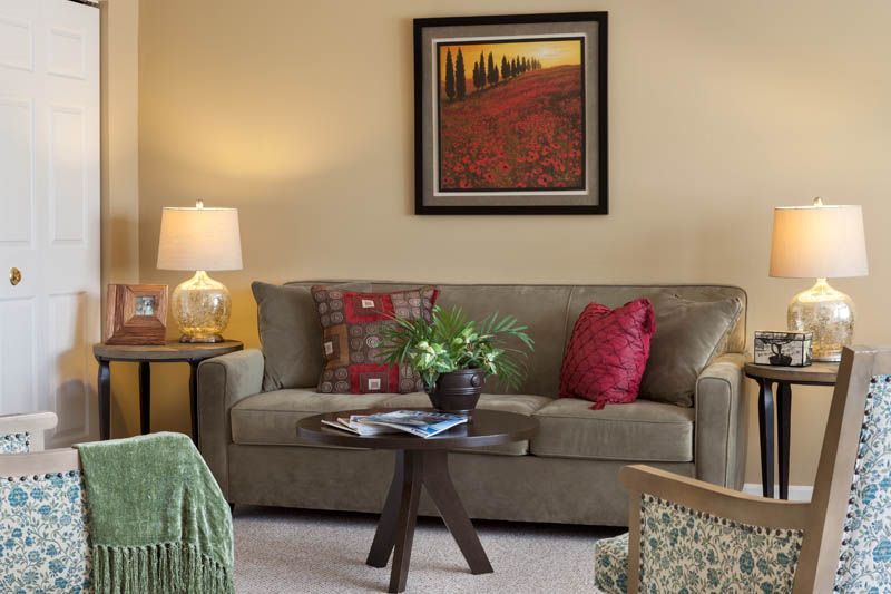 Senior living room at The Fountains At Crystal Lake with cozy couch, home decor, and furniture.