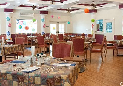 Interior view of Christian Care Manor IV senior living community featuring dining area and furniture.