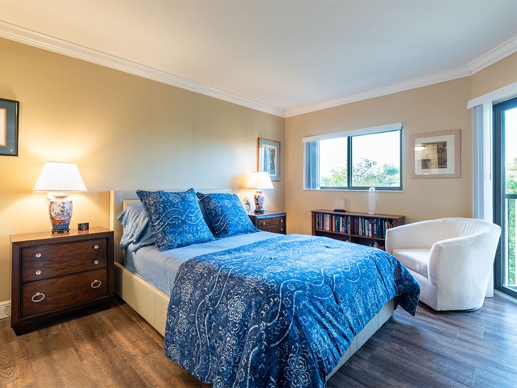 Corner bedroom with elegant furniture and decor at Pacifica Senior Living Forest Trace.