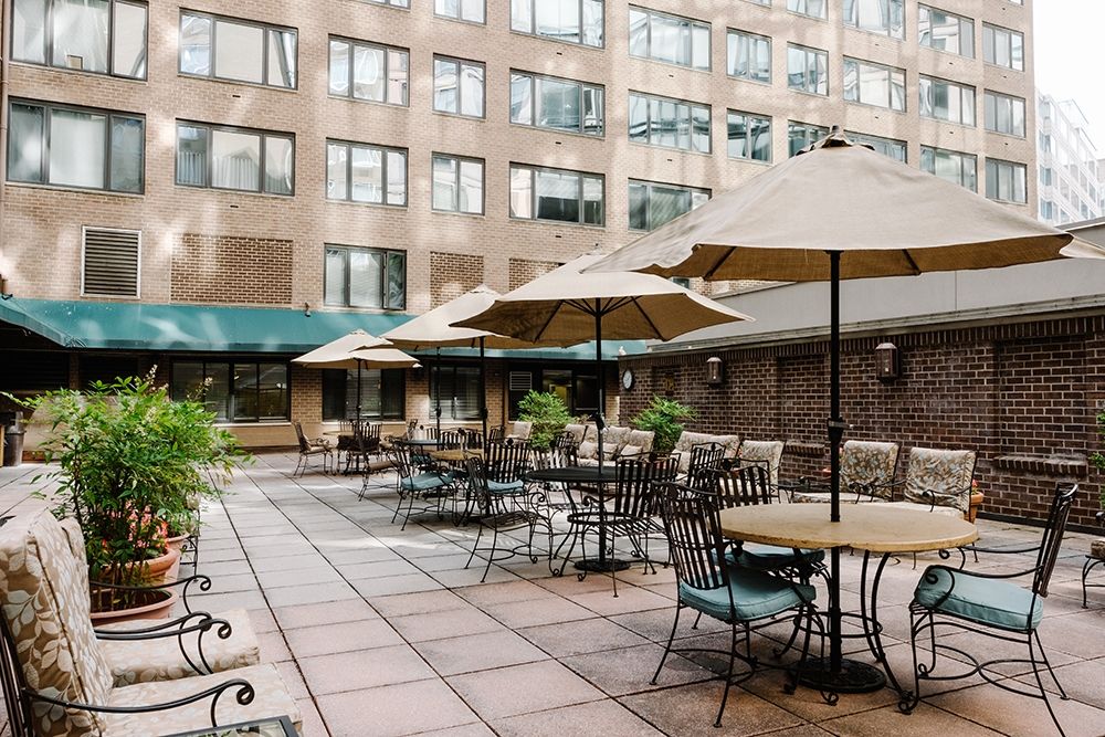 Senior living community at The Residences at Thomas Circle with urban architecture and patio dining.