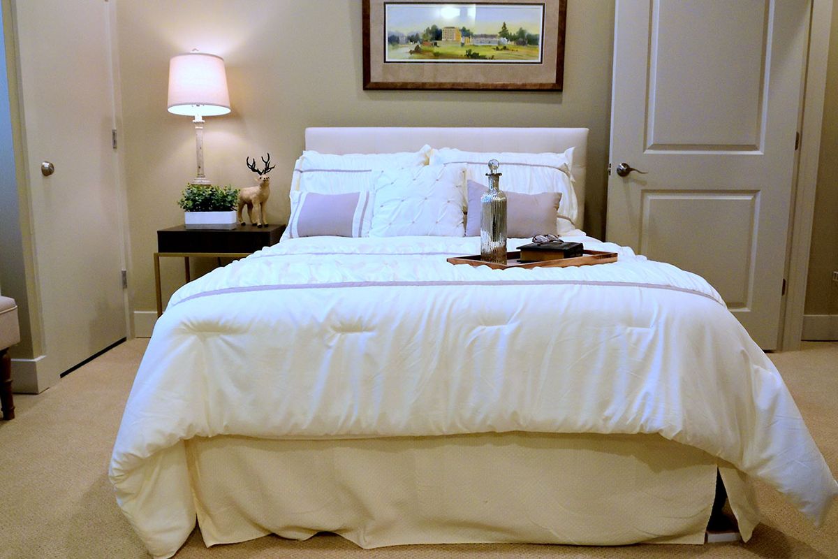 Interior view of a cozy bedroom in Avanti Senior Living at Covington with elegant home decor.