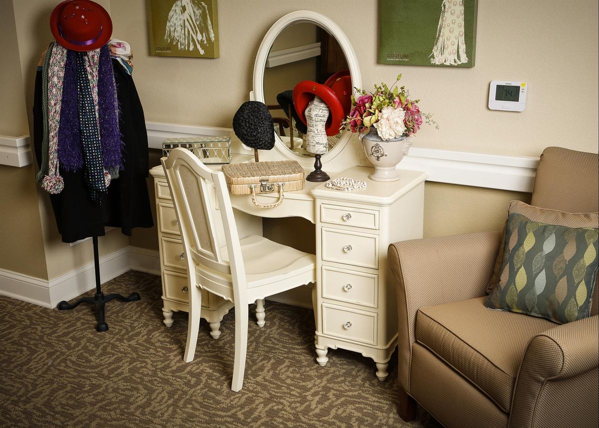 Elegant dressing room at The Gardens At Barry Road Assisted Living, featuring stylish home decor and plants.
