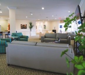 Interior view of Angels Senior Living At Sarasota featuring modern architecture, cozy furniture, and electronics.