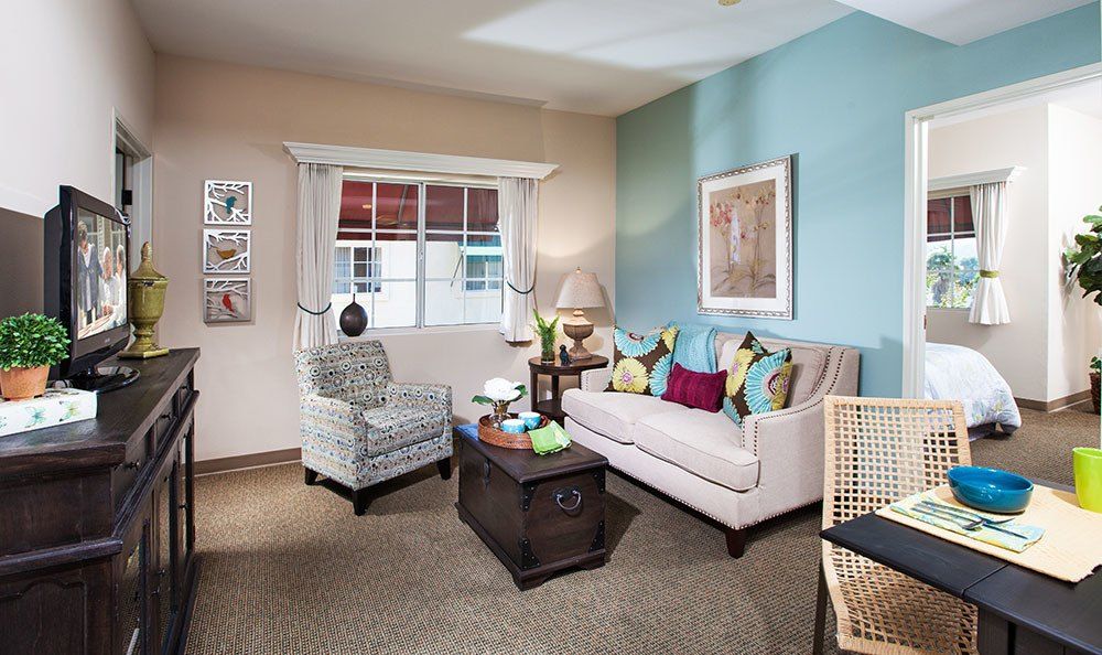 Senior living room interior at MorningStar of Pasadena with modern decor, furniture, and electronics.