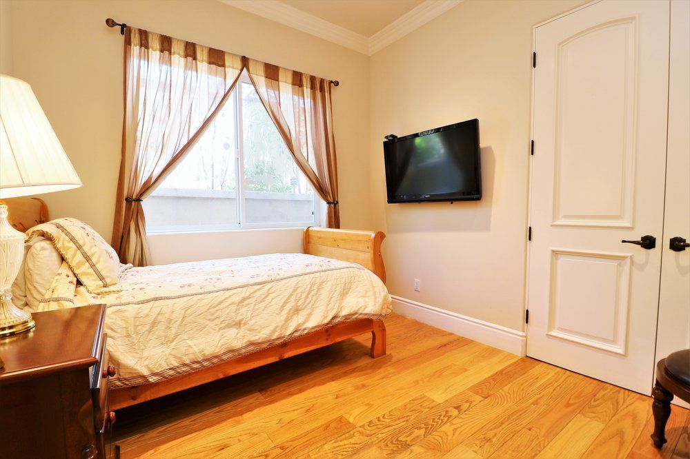 Interior view of Astoria Retirement Residences featuring modern decor, electronics, and hardwood flooring.