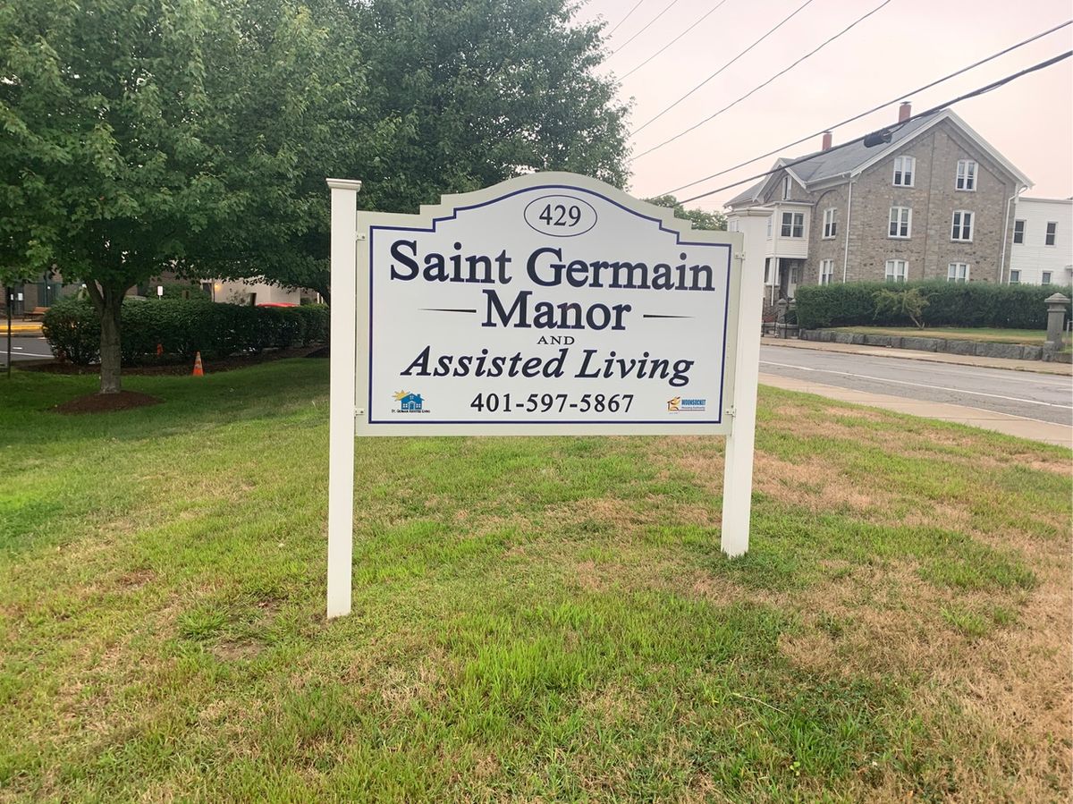 St Germain Manor, a senior living community with lush greenery and modern architecture in the city.