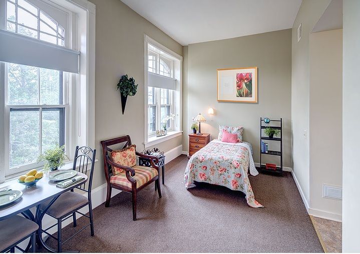 Elegant senior living room at The Clare Estate with tasteful decor, furniture and fresh pears.