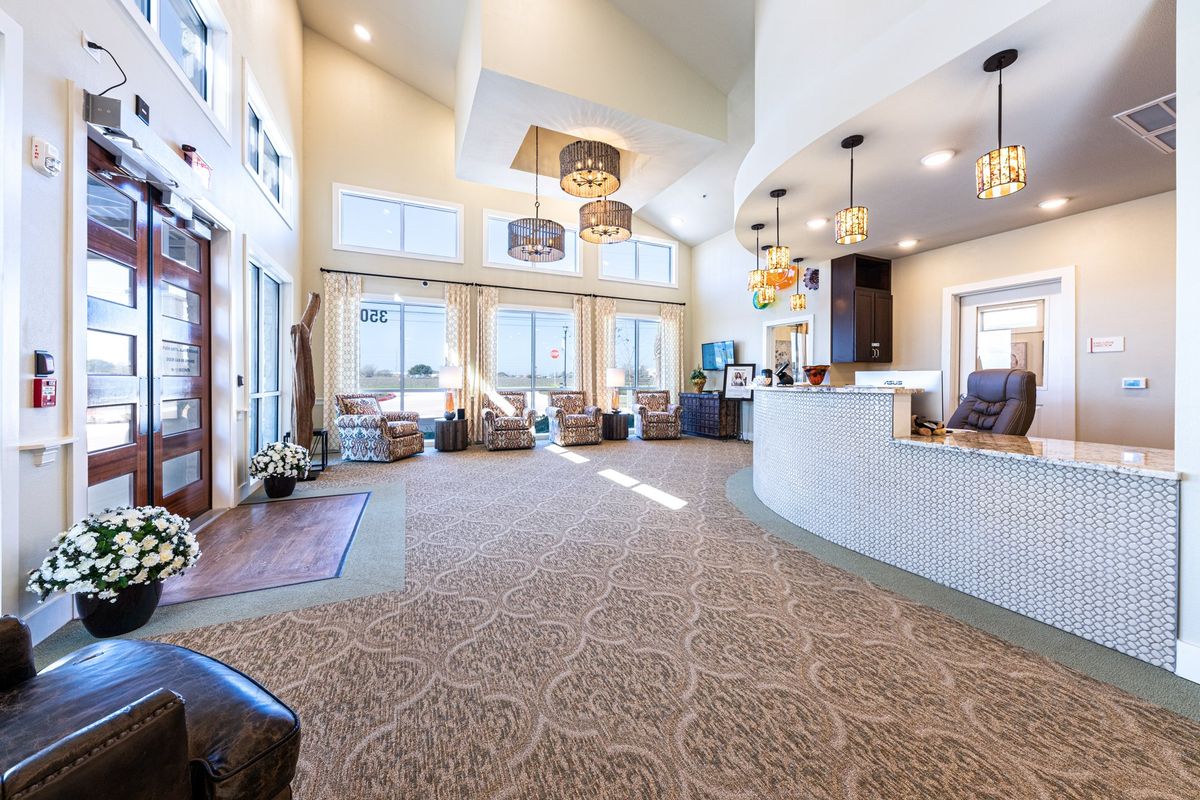 Senior living community foyer with elegant home decor, furniture, art paintings, and indoor plants.