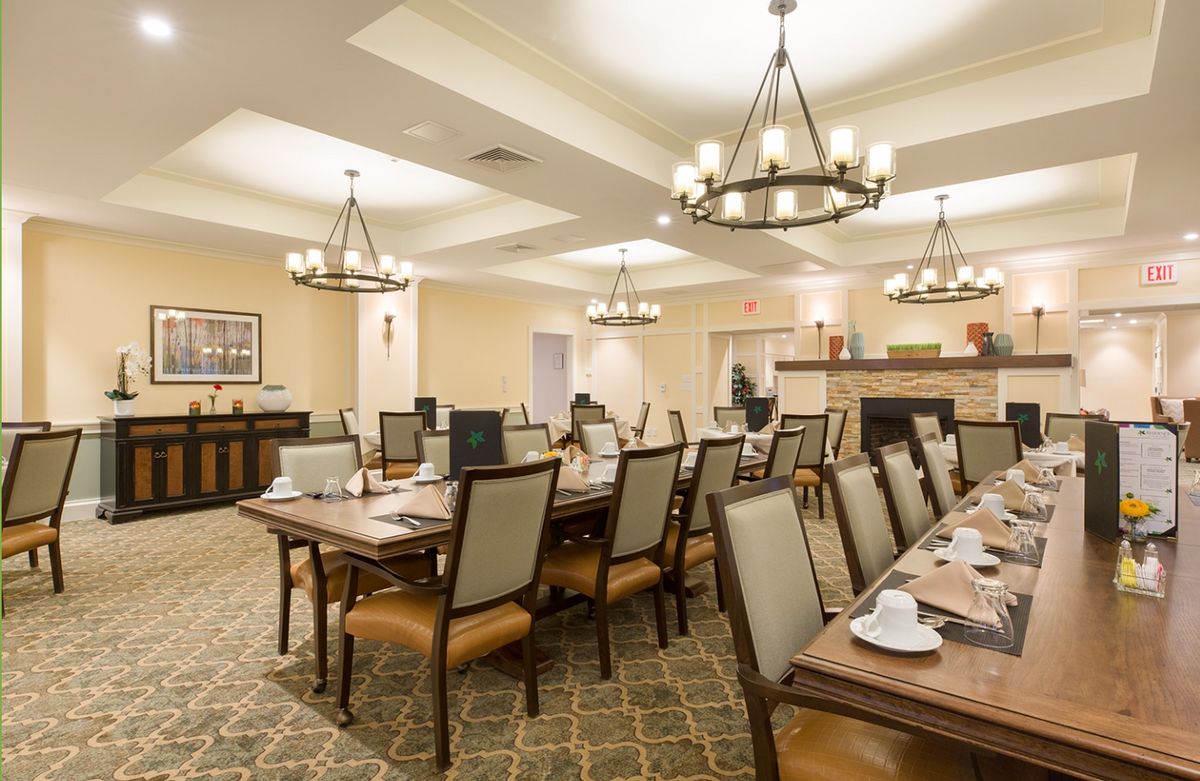 Senior living community dining room at The Residence at Orchard Grove with elegant furniture and decor.