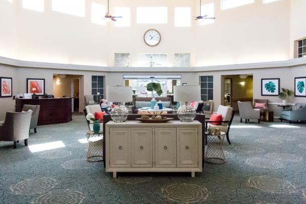 Interior view of Heron House senior living community featuring reception area, dining room, and living room.
