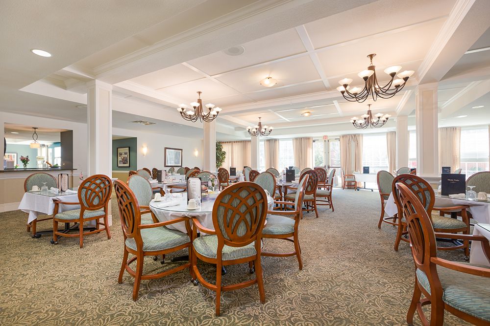 Interior view of Three Oaks Assisted Living and Memory Care featuring dining area and reception room.