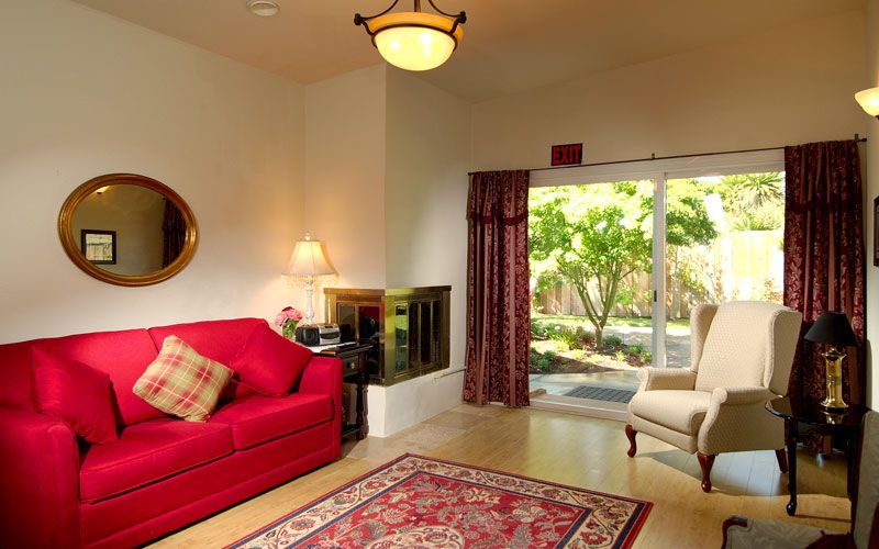 Interior view of a cozy living room in Three Home Village senior living community.