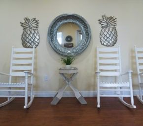 Comfortable furniture and lush plants inside Angels Senior Living community in Sarasota.