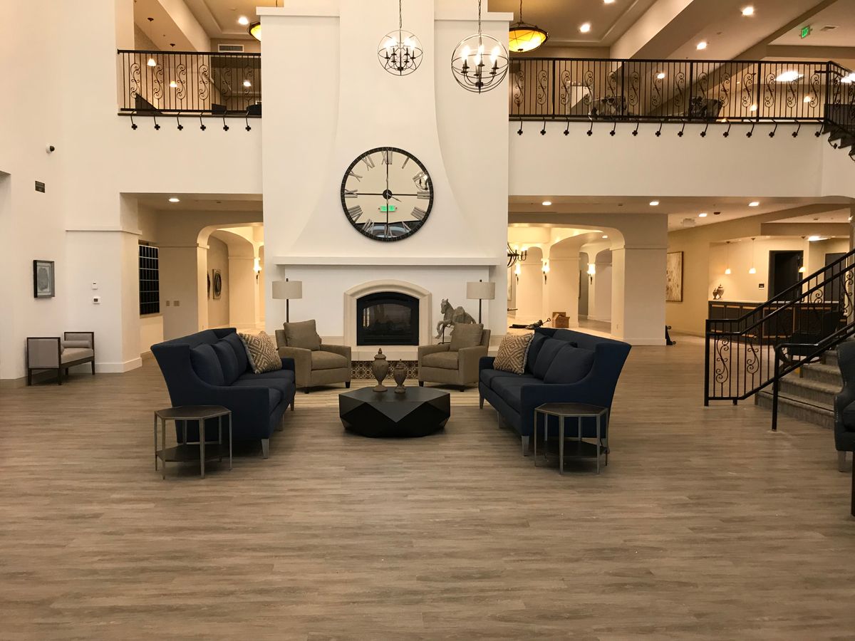 Senior resident relaxing in the well-furnished living room at The Villas At Stanford Ranch.