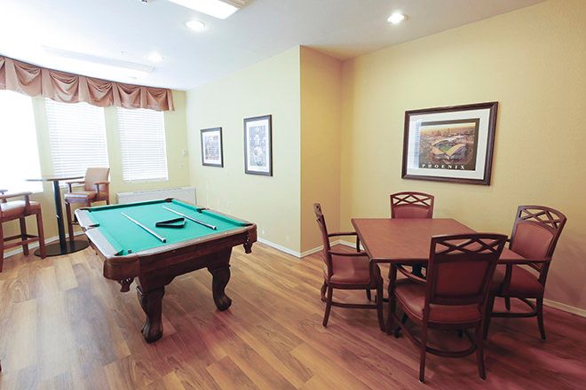 Senior living community Brookdale Baywood featuring dining room, billiard room with pool table.