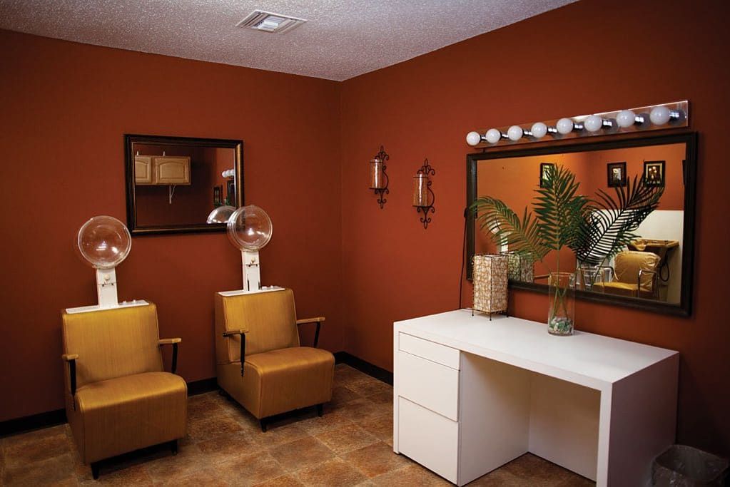 Interior view of St Ann Assisted Living Center featuring a cozy corner with furniture and salon.