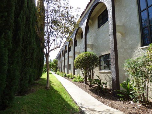 Mother Gertrude Home, a senior living villa in an urban city with lush greenery and a welcoming path.