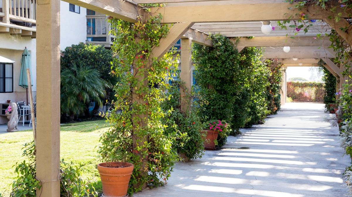 Senior living community Ivy Park at San Juan Capistrano featuring lush gardens, patios, and elegant interiors.
