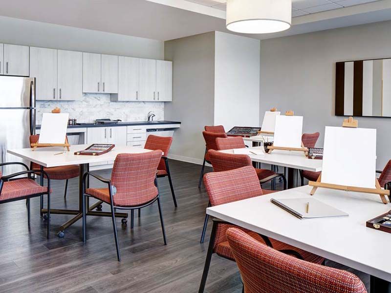 Interior view of Atria At River Trail senior living community featuring dining and kitchen area.