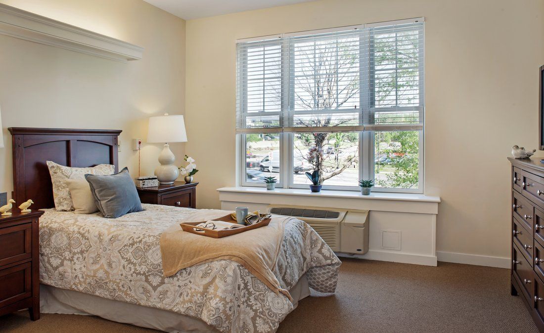 Interior view of a bedroom in Sunrise of Lenexa senior living community with elegant decor.