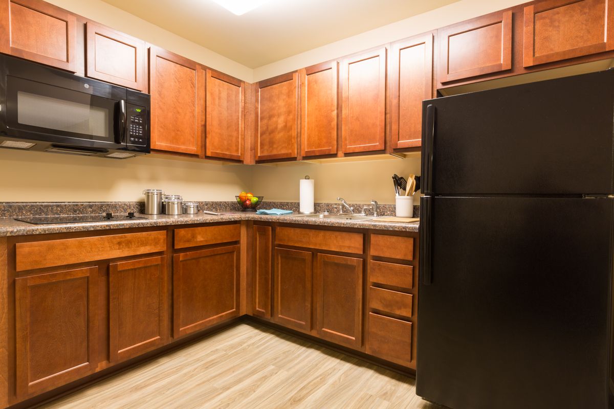 Interior view of a well-equipped kitchen with modern appliances at The Homestead at Hickory View Retirement Community.
