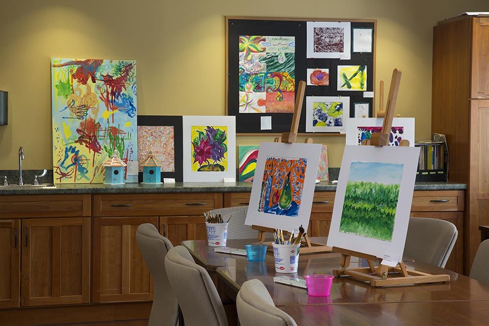 Interior view of Canvas senior living community featuring art gallery, furniture, and design.