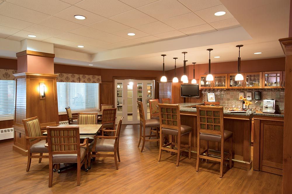 Interior view of Evans Park At Newton Corner senior living community featuring dining and kitchen area.