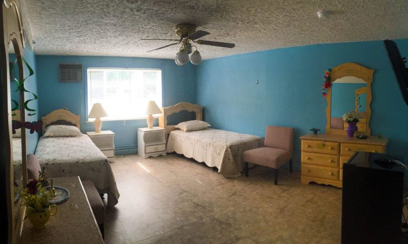 Interior view of a furnished bedroom in Bed, Bedroom, Dorm Room senior living community.