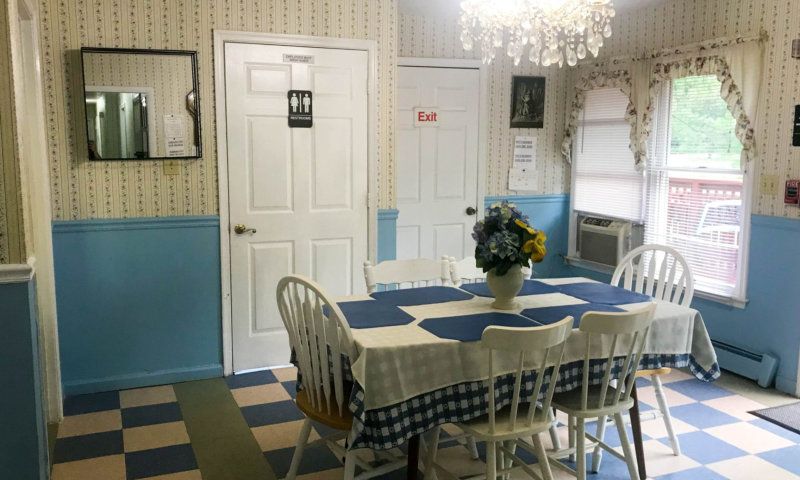 Interior view of Young At Heart senior living community featuring dining room with elegant furniture and decor.