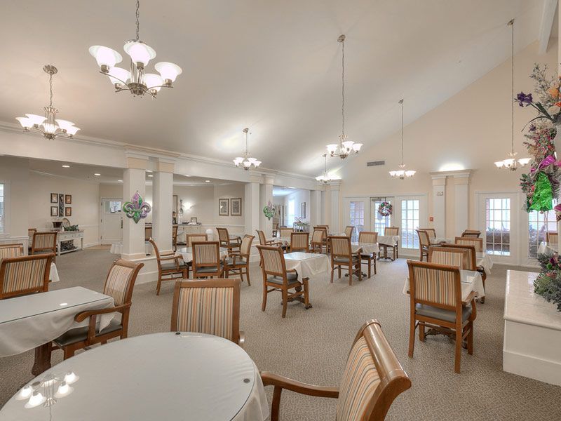 Interior view of Azalea Estates of Shreveport featuring dining room, reception area, and furniture.