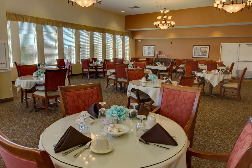 Senior living community dining room at The Landing of Long Cove with elegant decor and furniture.