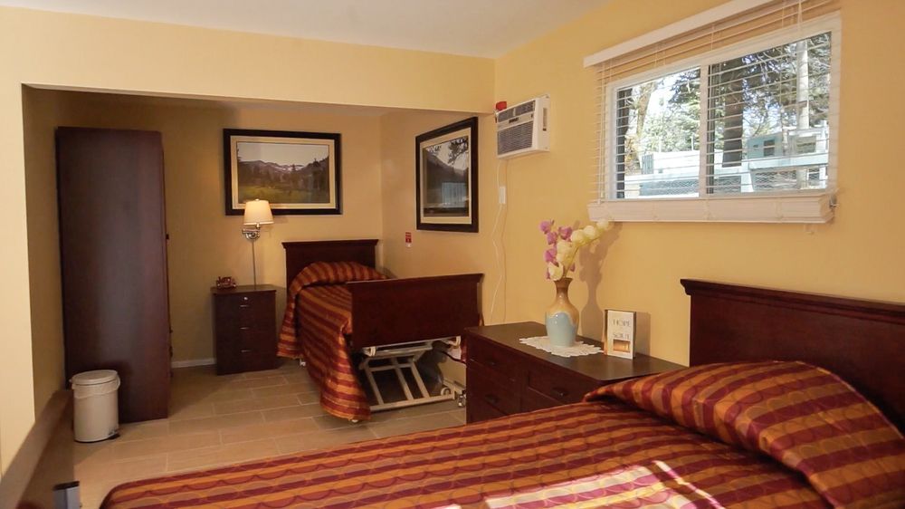 Interior view of a bedroom in Pacific Pines senior living community showcasing home decor.