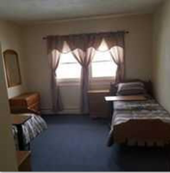 Senior living community Four Seasons Assisted Living featuring furnished bedrooms and cozy fireplace.