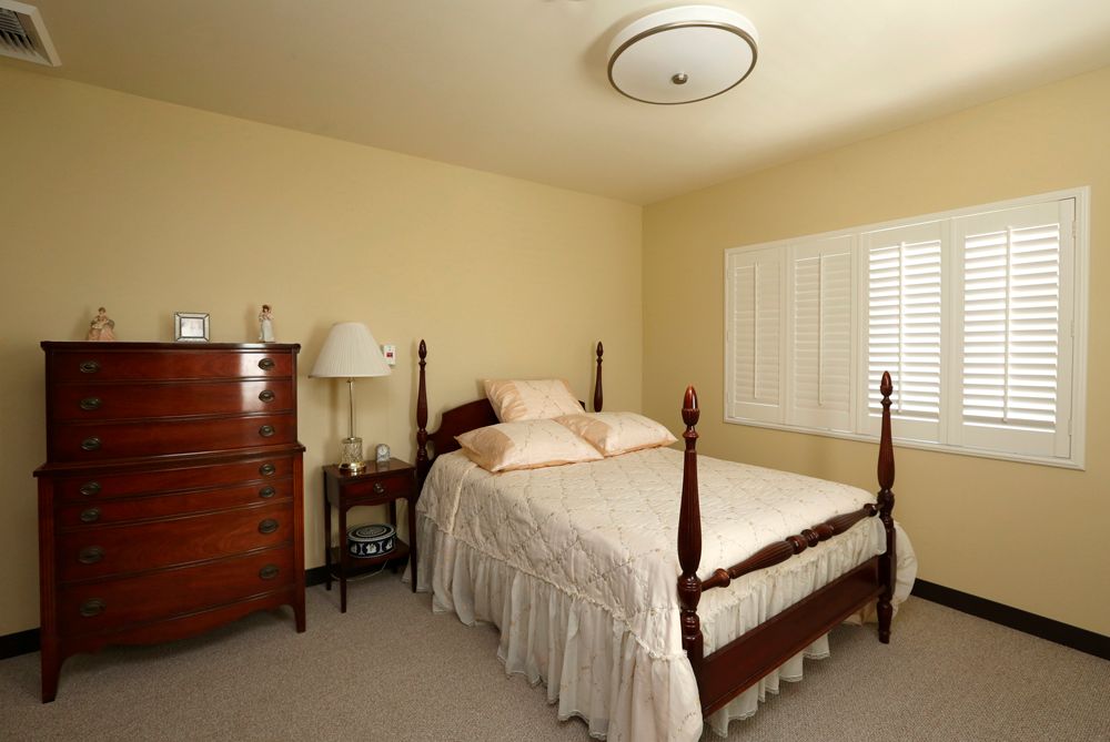 Interior view of a comfortable bedroom in Nazareth House senior living community.