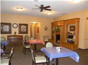 Senior living community Monticello House featuring architectural building, indoor dining area with furniture.