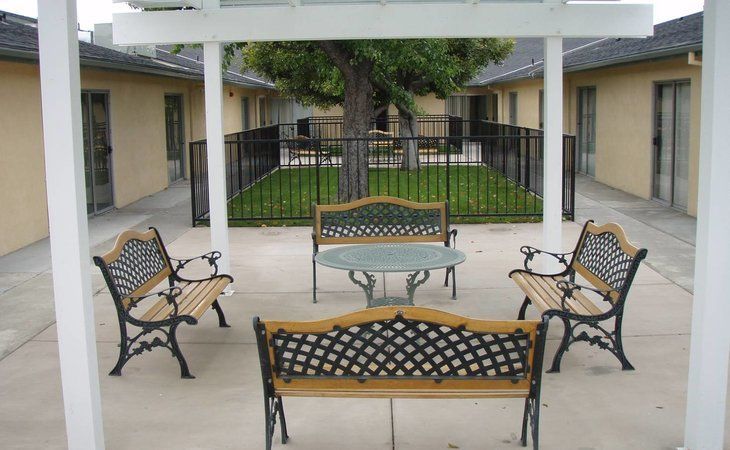 Senior living community, Lakewood Gardens, featuring a backyard patio with outdoor furniture.