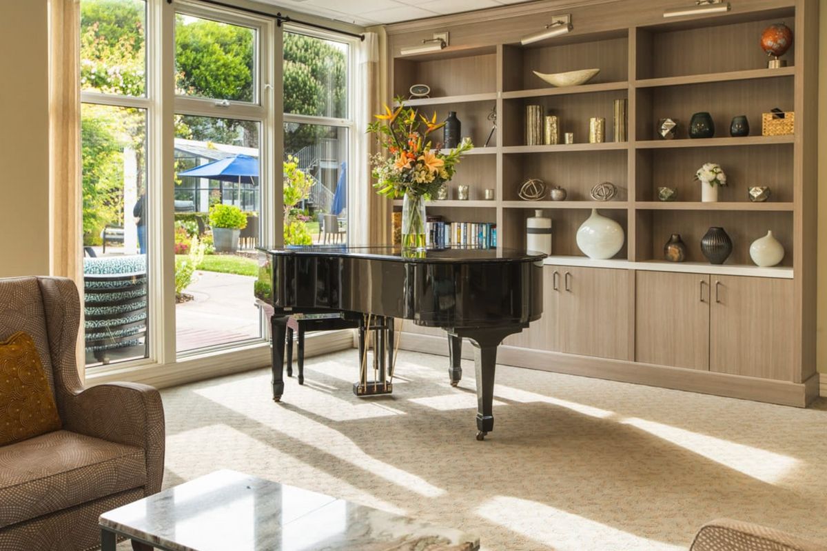 Senior playing piano in a beautifully decorated living room at Sagebrook Senior Living, San Francisco.
