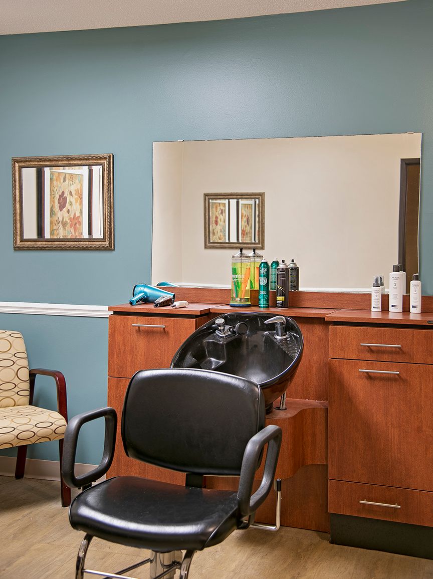 Indoor view of American House Livonia senior living community featuring salon and barbershop.
