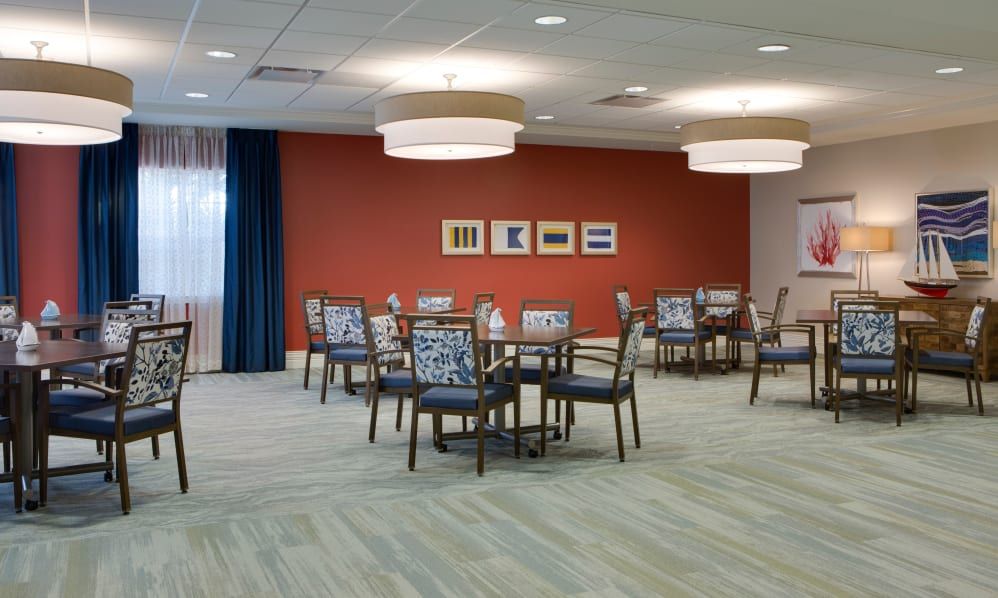Senior residents dining in the elegant cafeteria of Beach House at Wiregrass Ranch.
