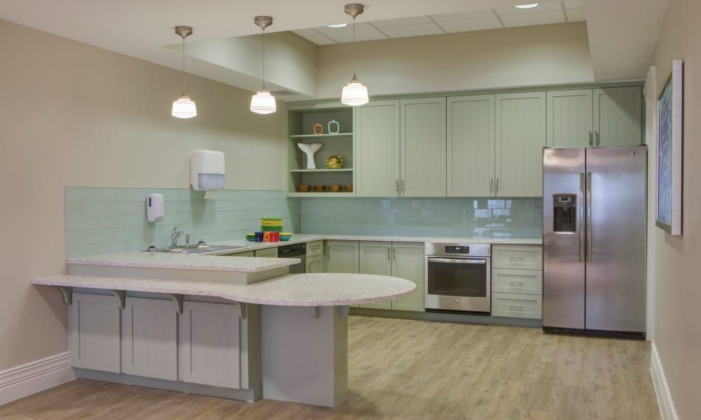 Interior of Beach House at Wiregrass Ranch senior living community featuring a well-equipped kitchen and artful decor.