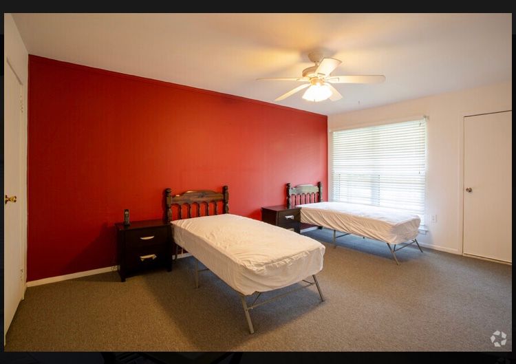 Interior view of a comfortable bedroom in Heart of Hearts senior living community.
