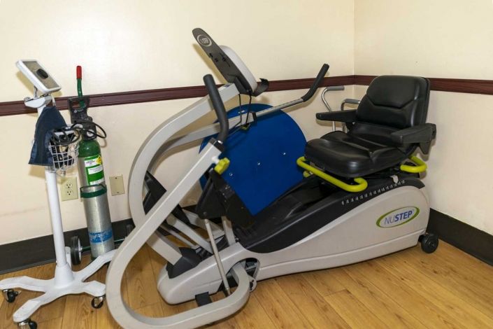 Seniors at Claremont Care Center enjoying gym workouts and e-scooter rides for fitness.
