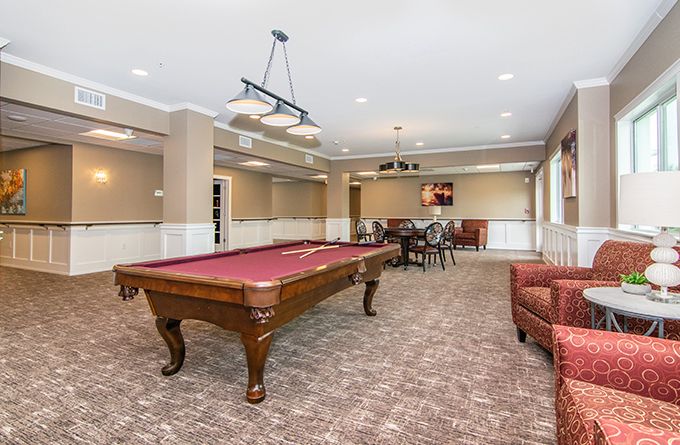 Senior living community Hampton Manor of Trenton featuring dining area, billiard room, and cozy lounge.
