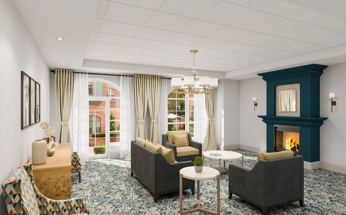 Senior living room interior at The Residence At Boylston Place with elegant furniture and fireplace.